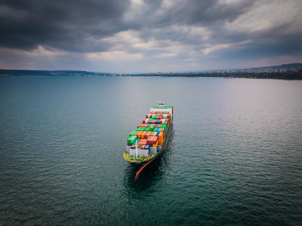 A loaded container ship in the sea, aerial view, concept of international trade and shipping